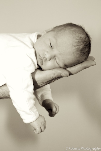 Baby in fathers hand - newborn portraits